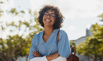 Medium shot of a young healthcare professional smiling at the camera